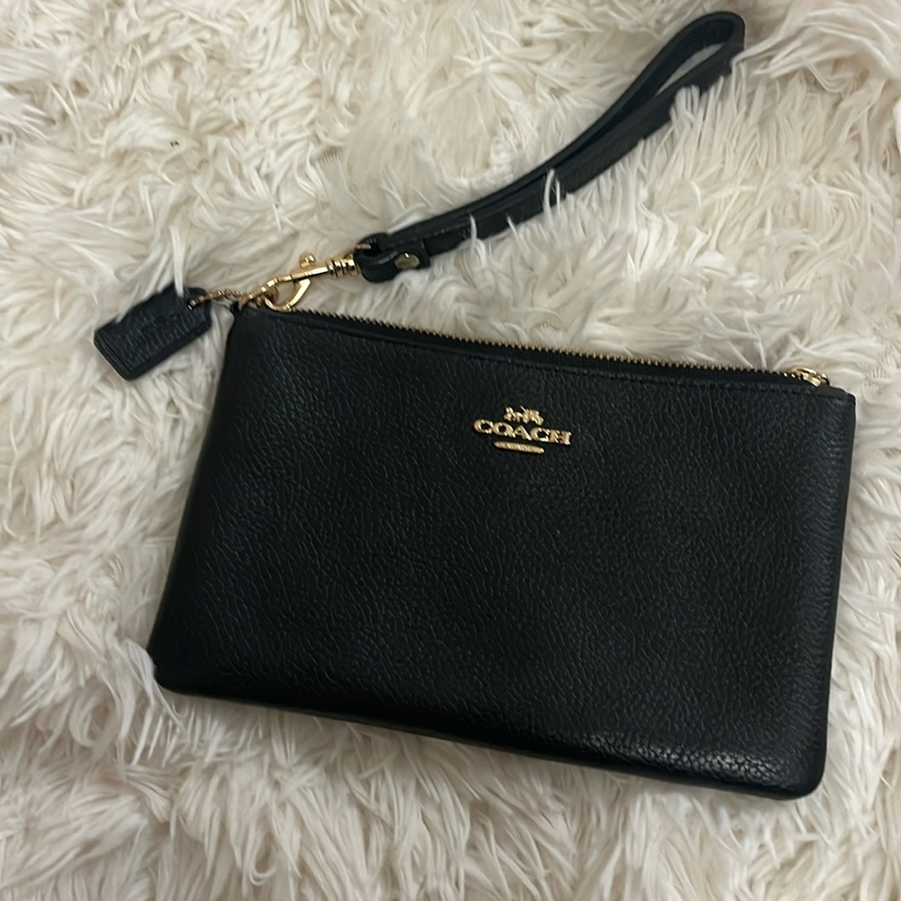 Coach black pebble leather zip top wristlet with gold color hardware. EUC